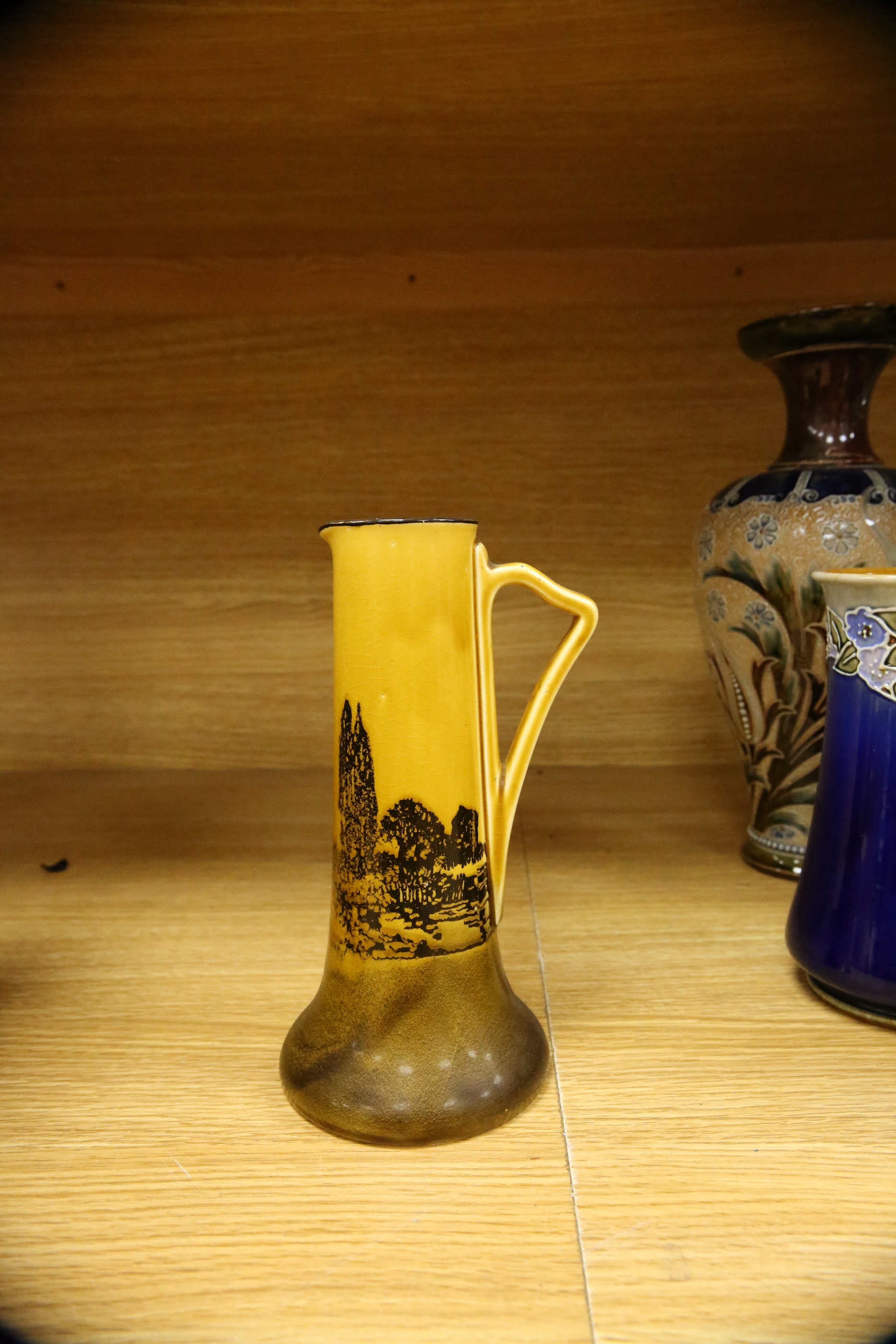 Four Royal Doulton vases and a yellow glazed jug items, tallest vase 34cm high. Condition - some crazing and faults, large vase has damage to lower neck